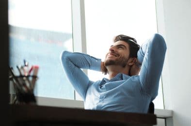 A picture of a person sitting on a chair and enjoying a moment of relaxation.